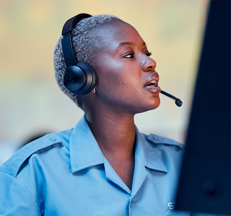 Lady security officer in call centre, representing a transformed workforce empowered by Elevate labour management system for security.