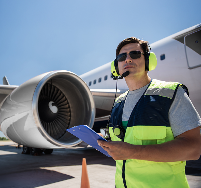 Airport worker with aeroplane, representing Elevate workforce management program ensuring automated compliance and optimal staff scheduling.