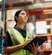 Engaged Warehouse Workforce Young warehouse worker in high-vis happily on shift, symbolising an engaged and efficient workforce managed by Elevate logistics solutions.